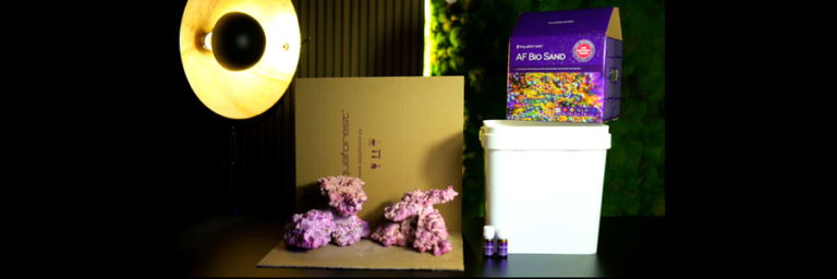 Aquaforest reef aquarium setup products with reef rock, AF Bio Sand, aquarium tank and aquascaping materials.